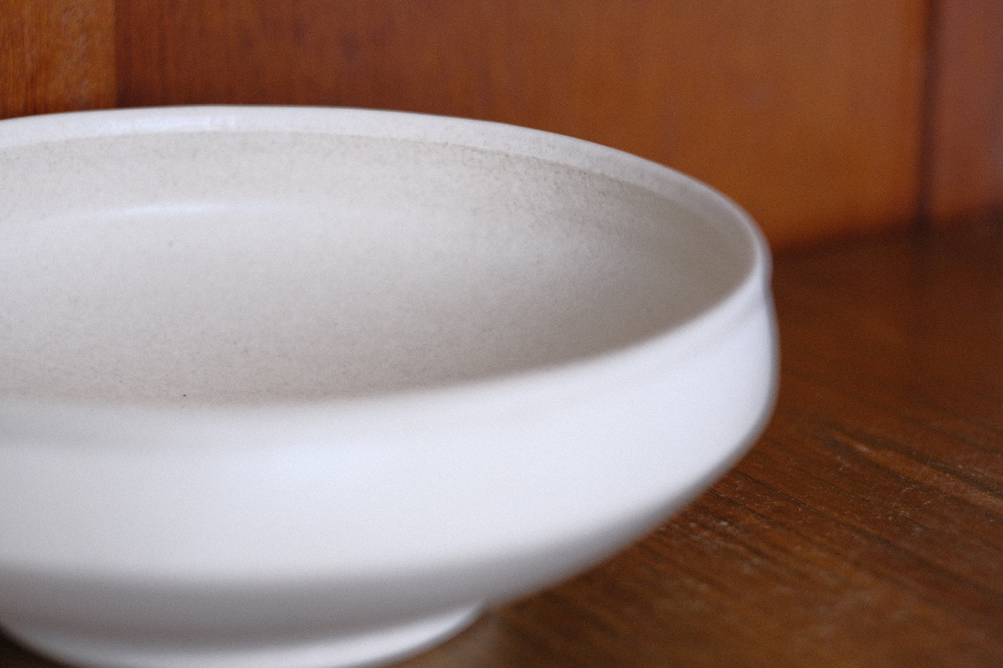 Off-white closed rim shallow bowl