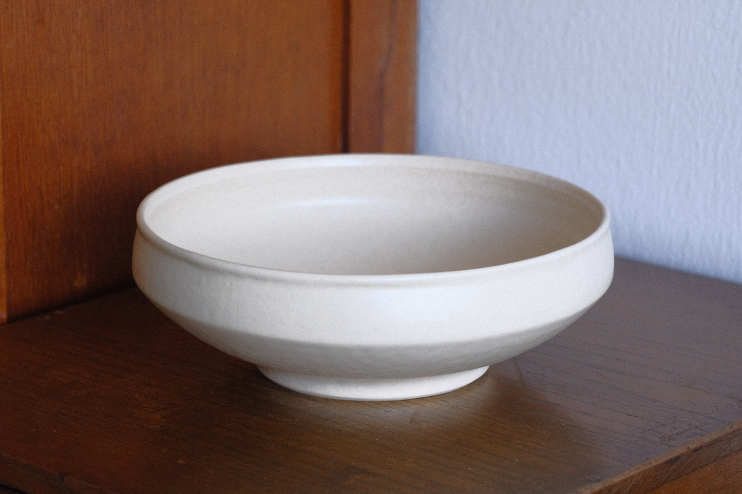 Off-white closed rim shallow bowl